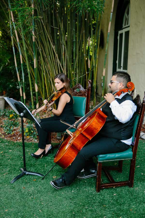 two people playing violin