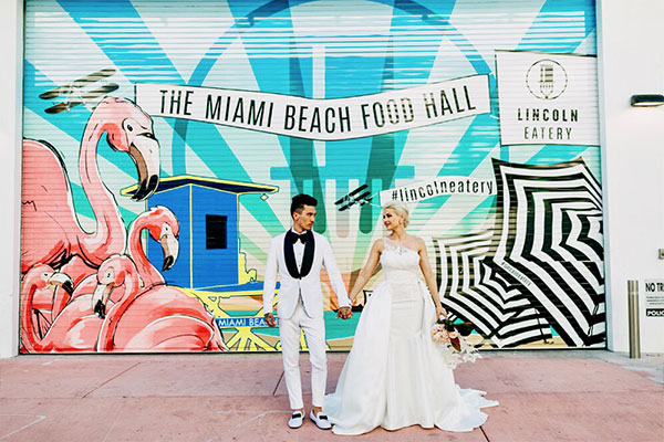 wedding couple in front of mural